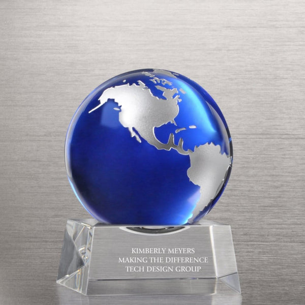 Elegant trophy: a vivid Earth sphere set on a transparent acrylic base, etched with ‘You Make a World of Difference’ text.