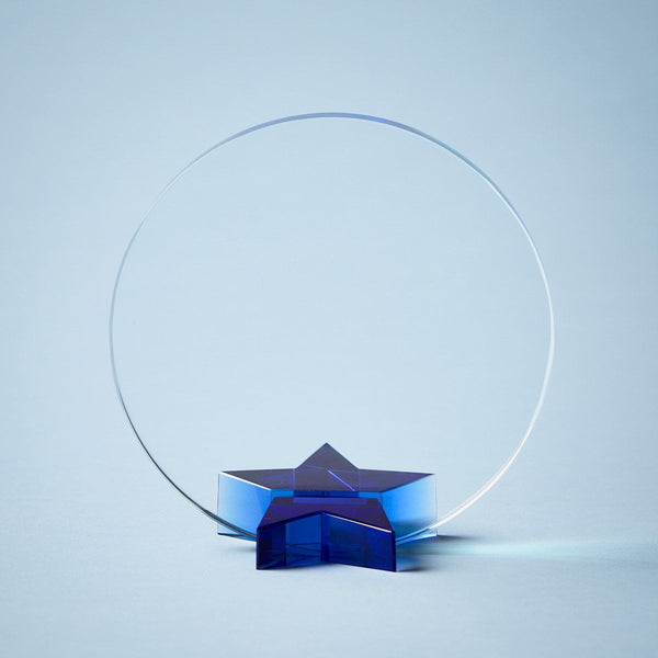 Round glass recognition award featuring a blue acrylic star base, customizable for employee achievement, service awards, and corporate recognition programs.