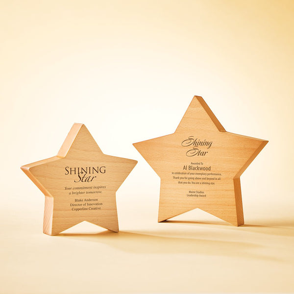 Two personalized wooden star plaques with engraved text, displayed on a warm beige background.